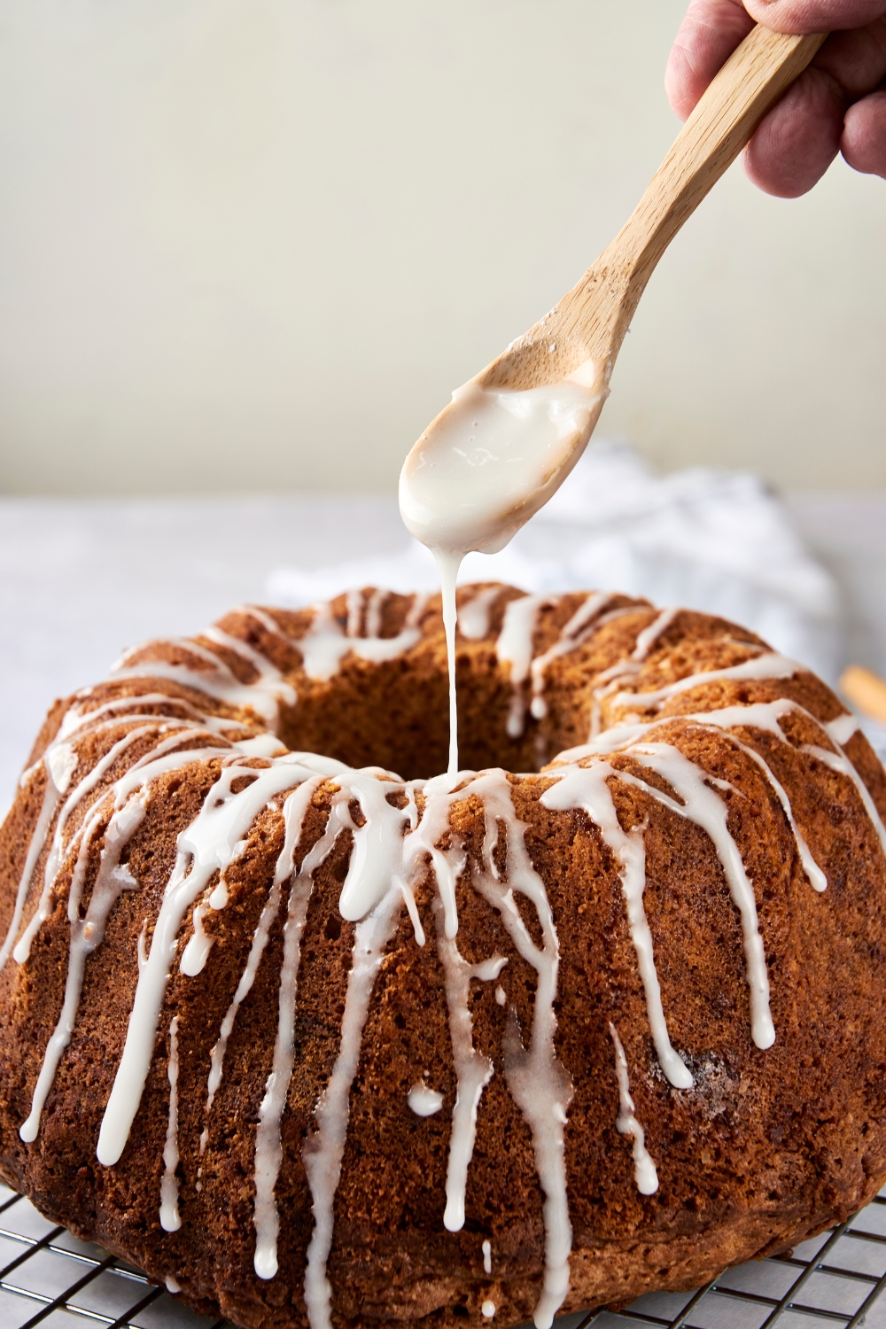 A bundt cake being glazed.