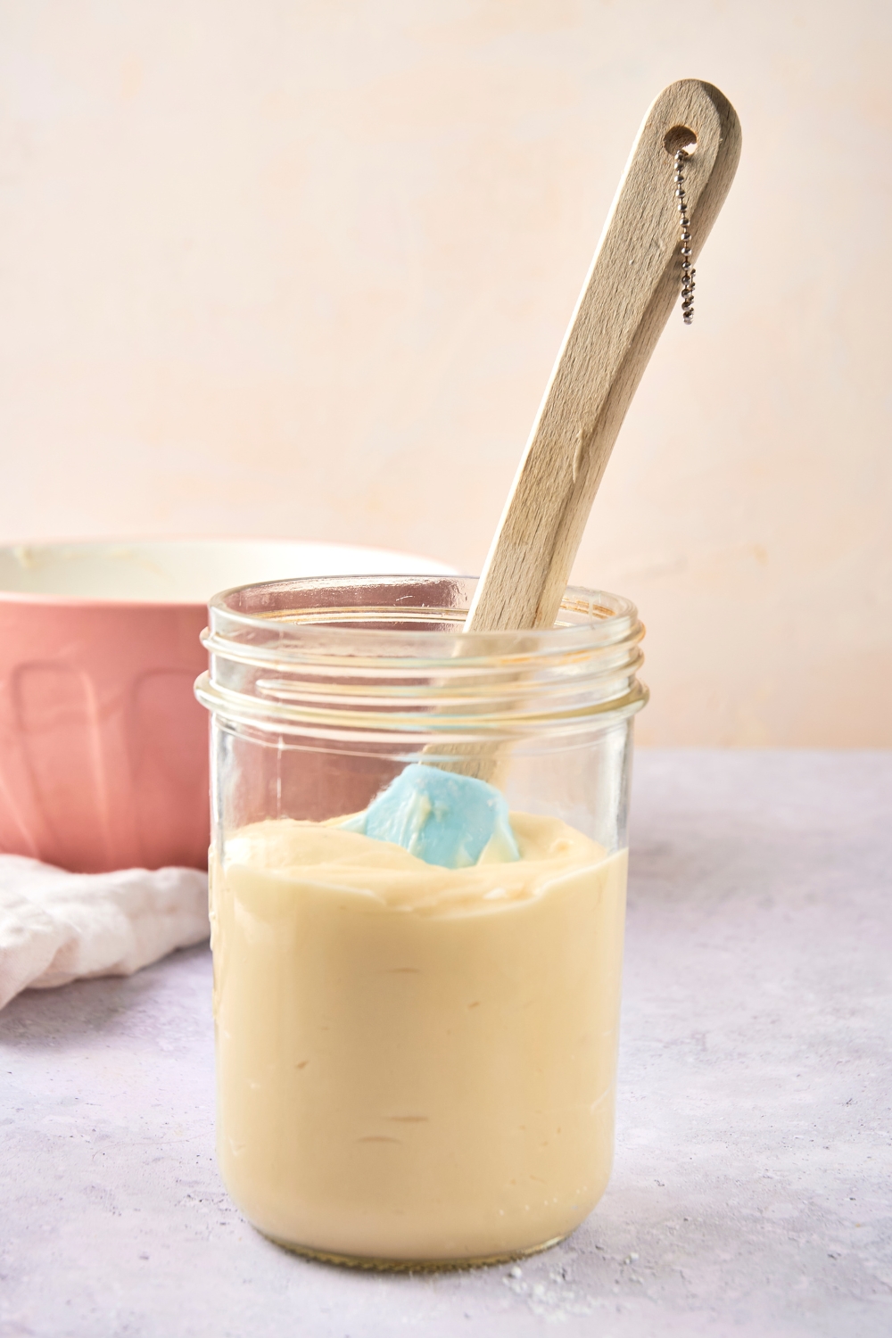 A mason jar with cream cheese frosting.