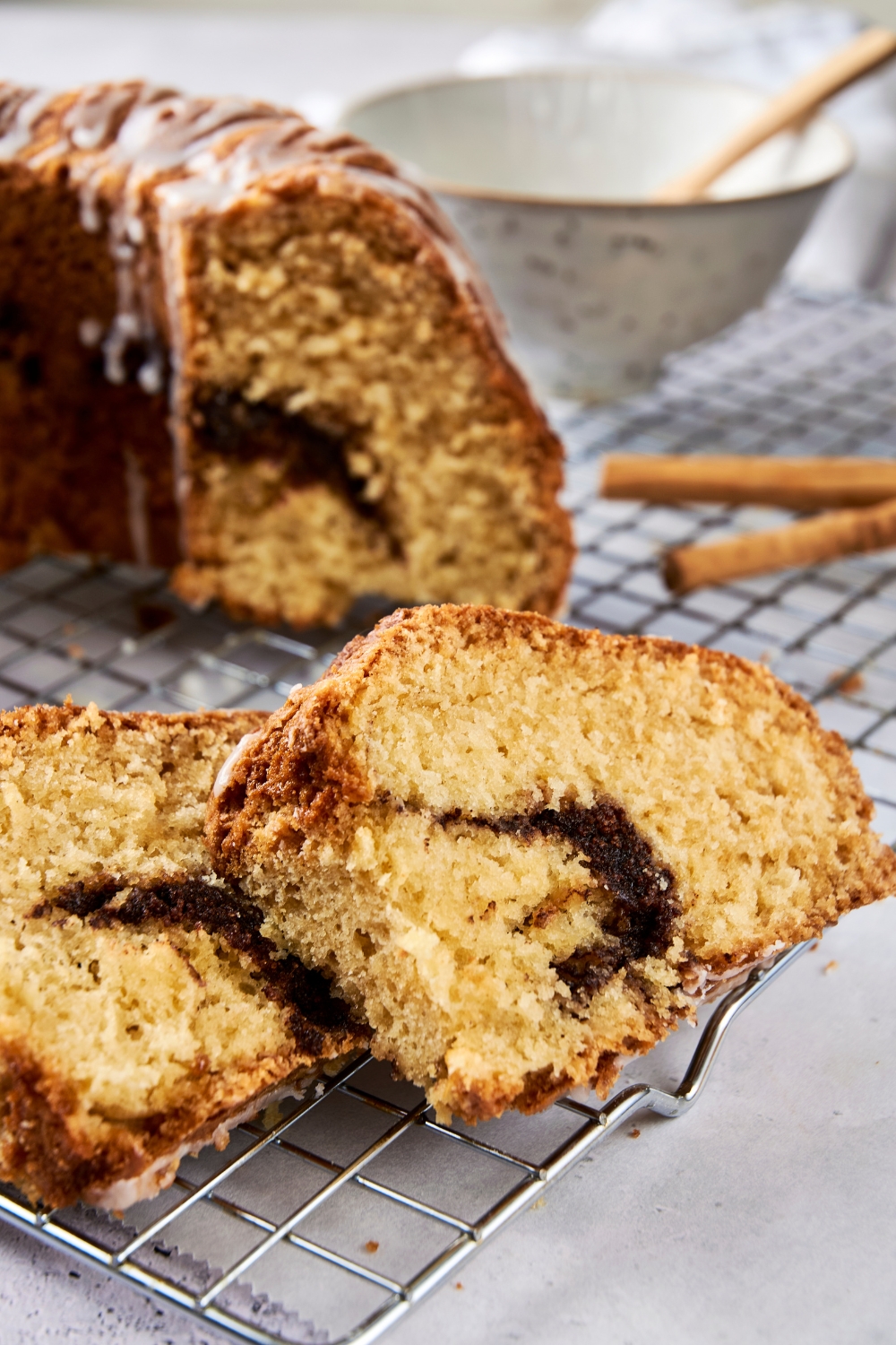 Two slices of cinnamon bundt cake glazed with icing.