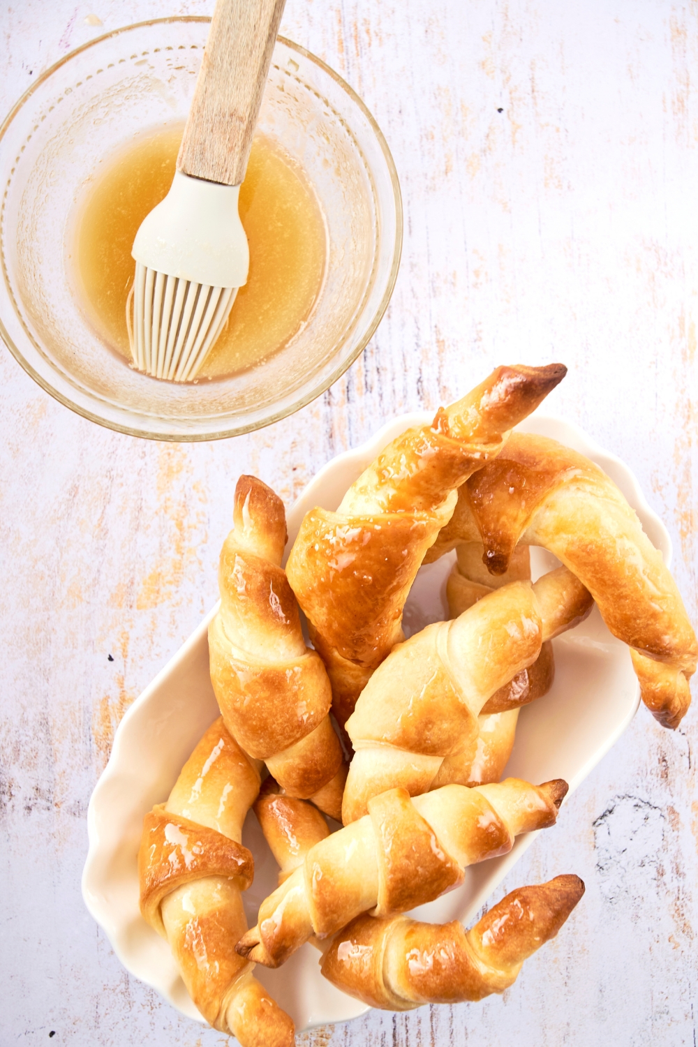 A serving dish is piled high with golden brown Cheddar's croissants.
