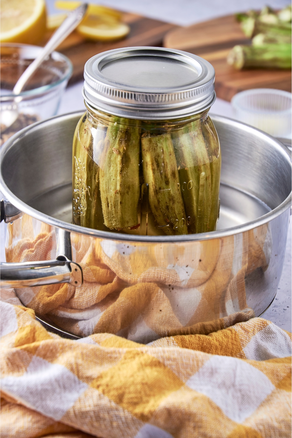 A jar sitting in the pot of boiling water.