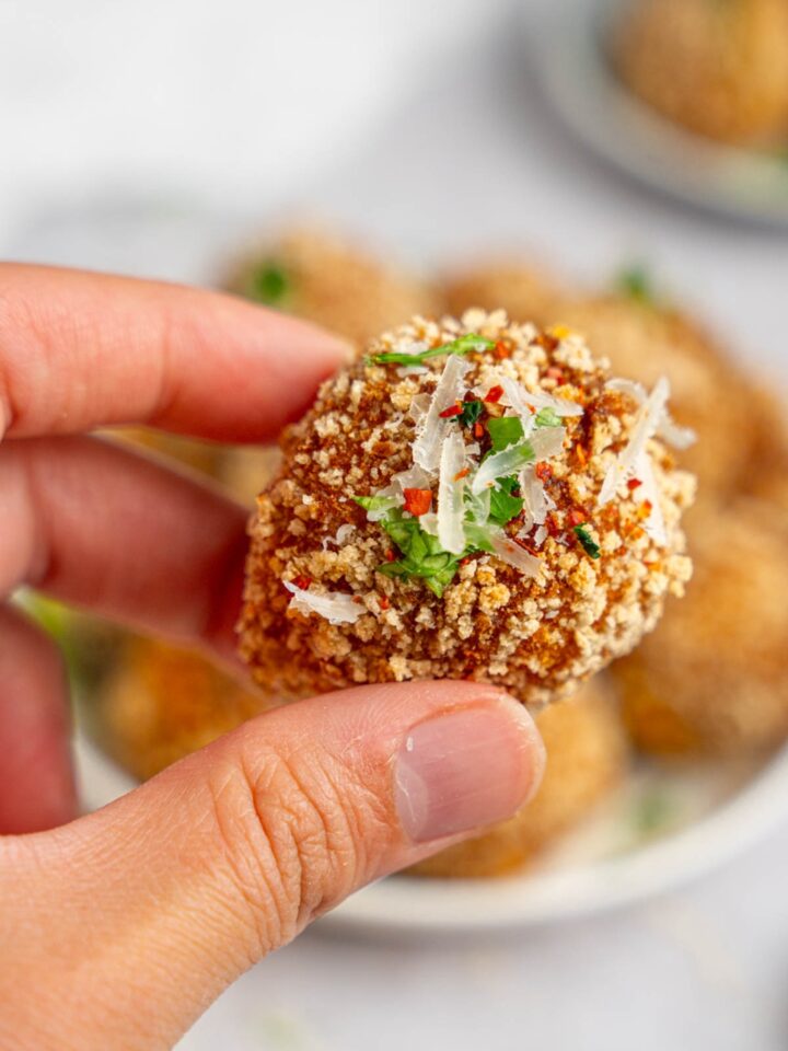 A hand holding a mashed potato ball.