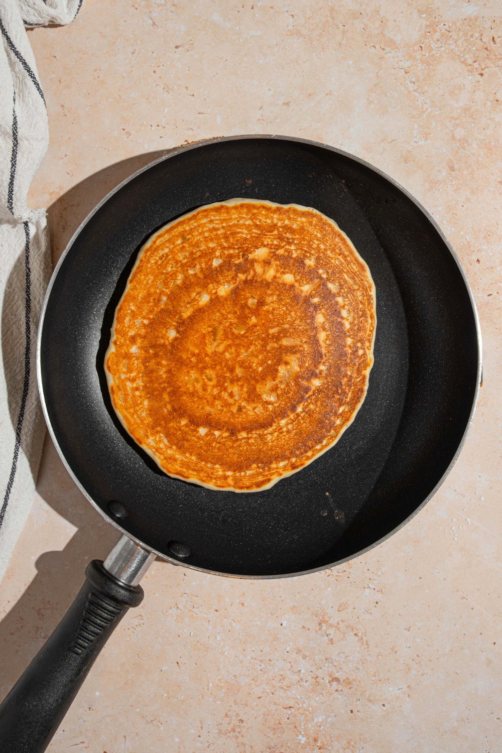 A cooked pancake in a skillet.