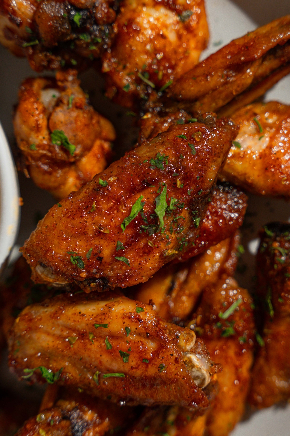 Copycat Wingstop Louisiana rub wings garnished with fresh parsley.