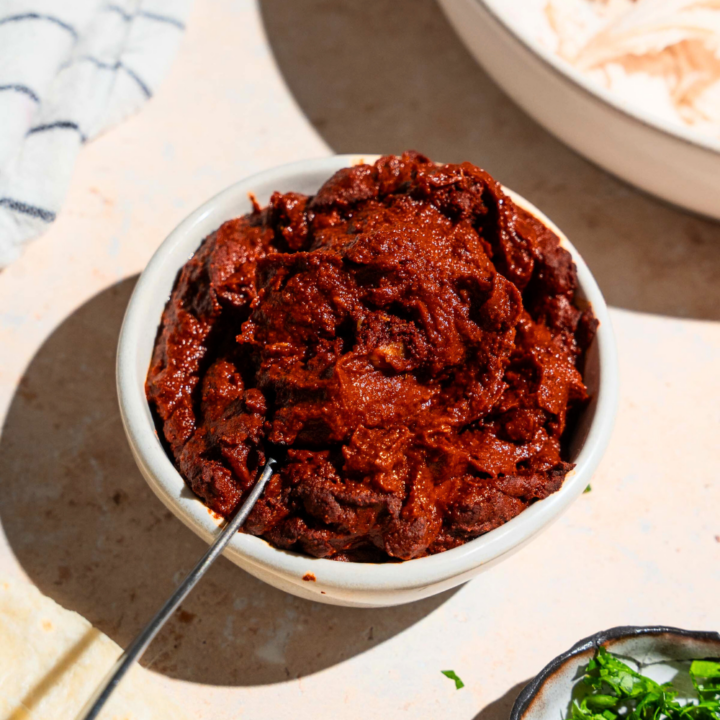 A white bowl filled with adobo sauce.
