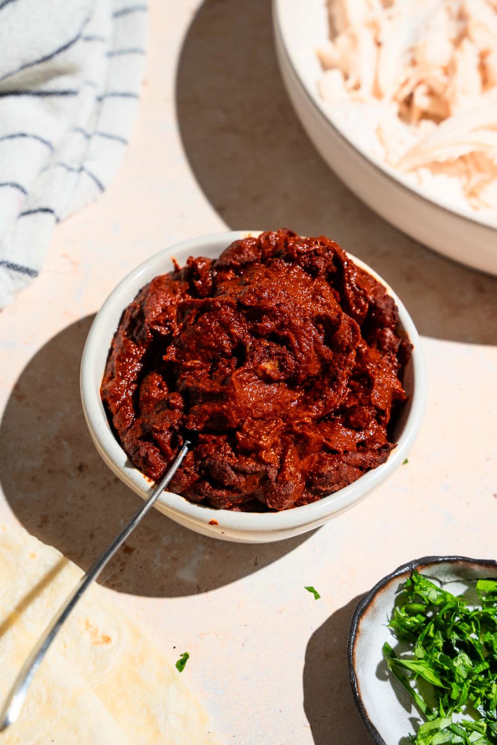 A white bowl filled with adobo sauce.