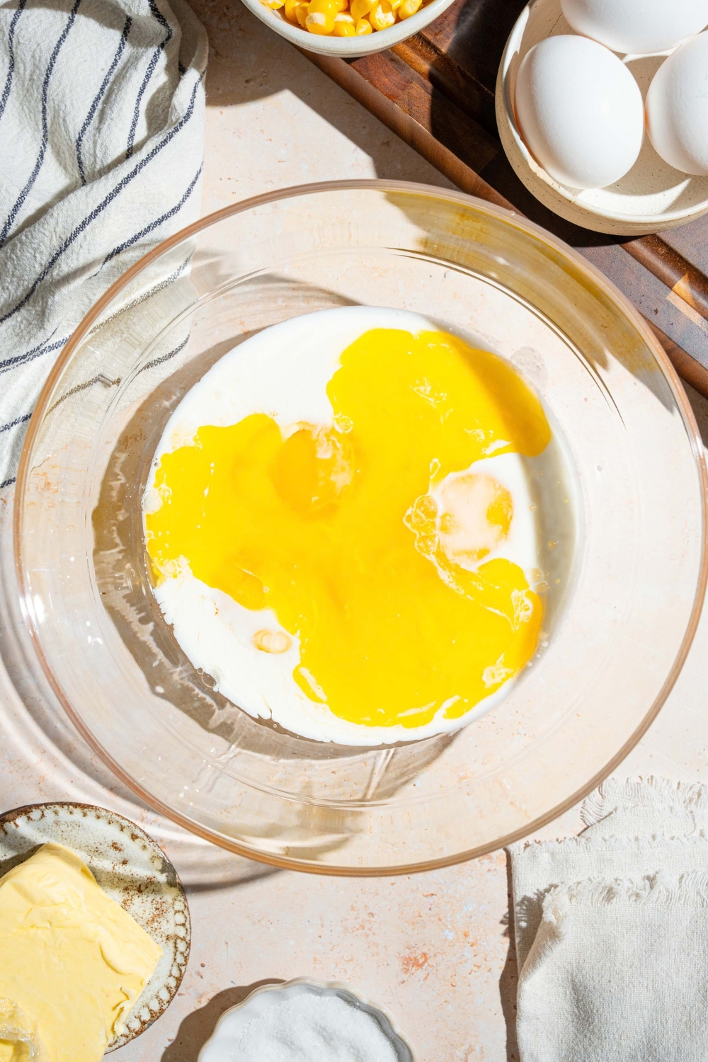 Melted butter and milk in a glass bowl.
