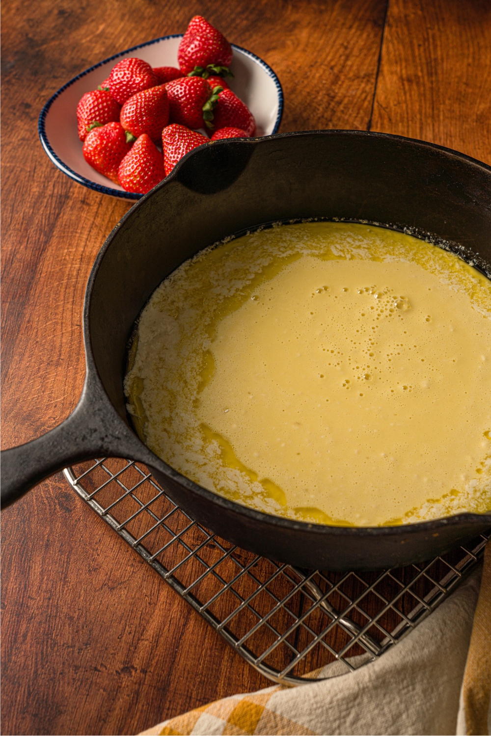 A skillet with german pancakes batter in it.
