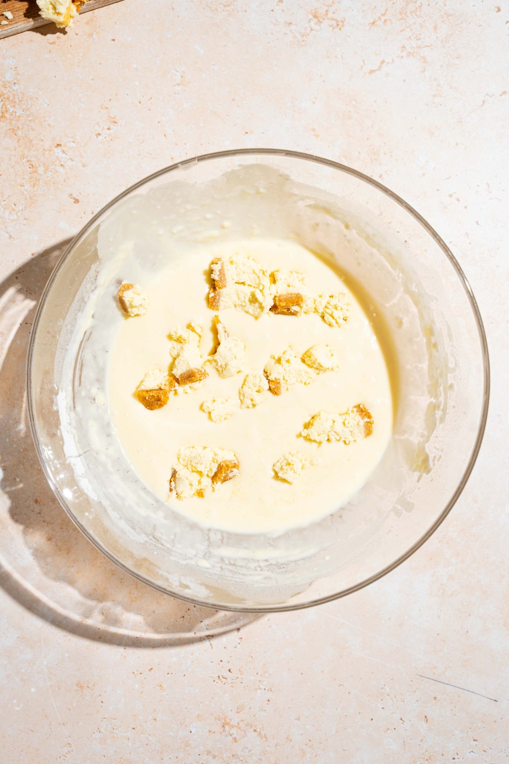 A bowl with IHOP New York cheesecake pancake batter. The bowl is on a tan counter.