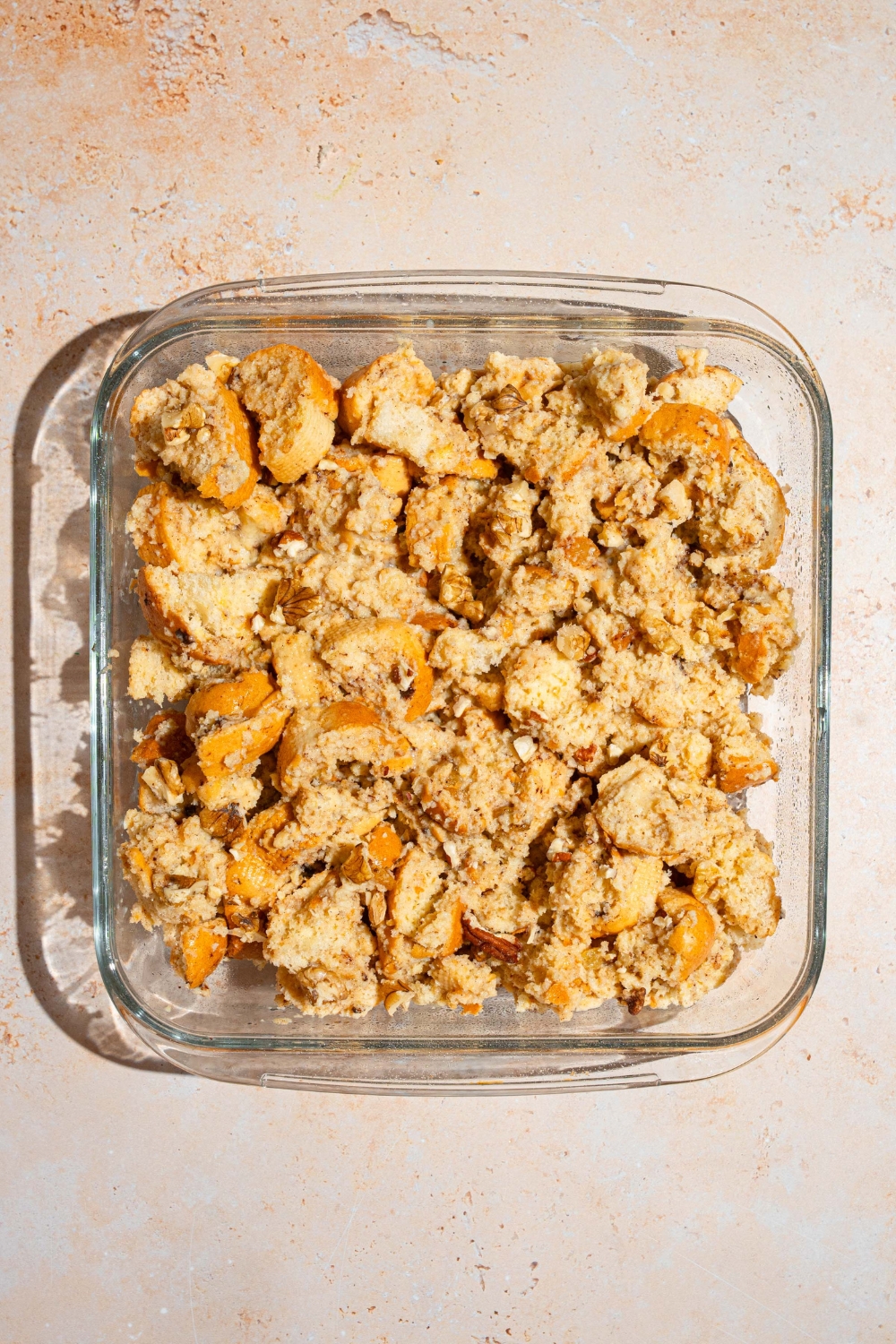 A baking dish with baked bread pudding. The dish is on a tan counter.