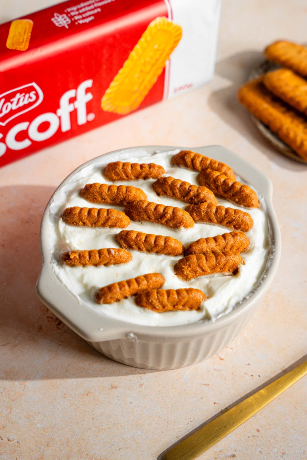 A bunch of Biscoff cookies set in yogurt in a ramekin.