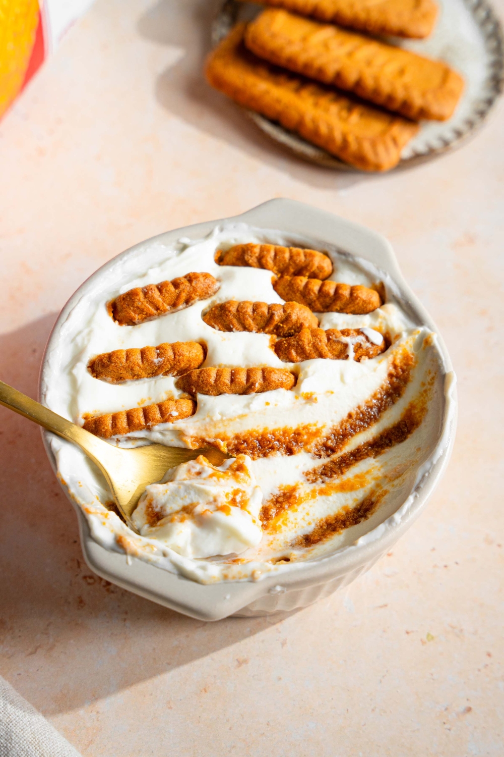 A bowl of viral yoghurt cheesecake consisting of yoghurt and Biscoff cookies.