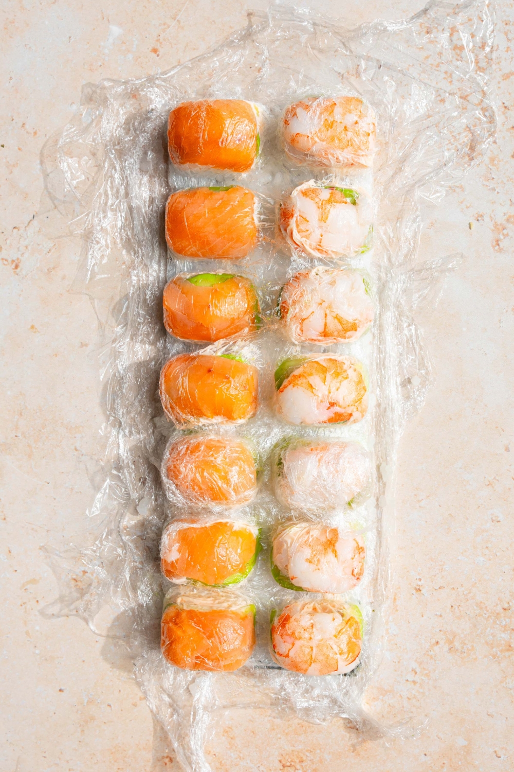 An ice cube tray filled with pieces of sushi.