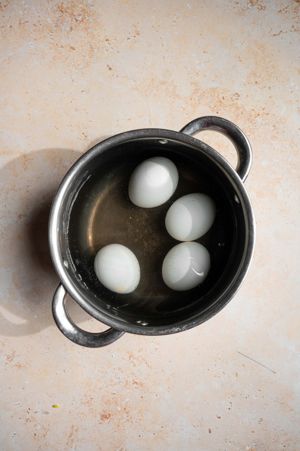 Four eggs in a pot of water for mayak eggs.