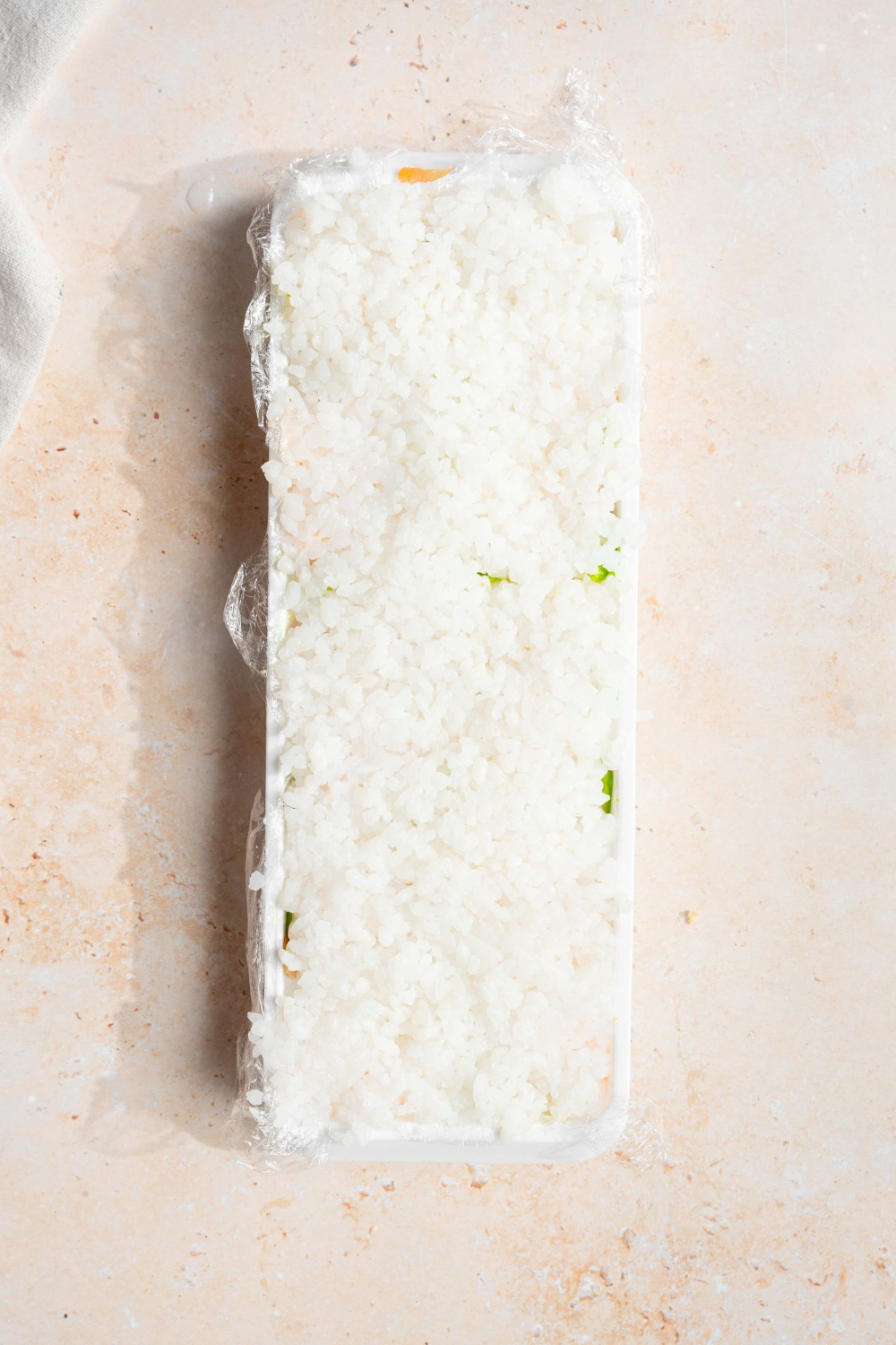 A bit of rice on top of an ice cube tray.