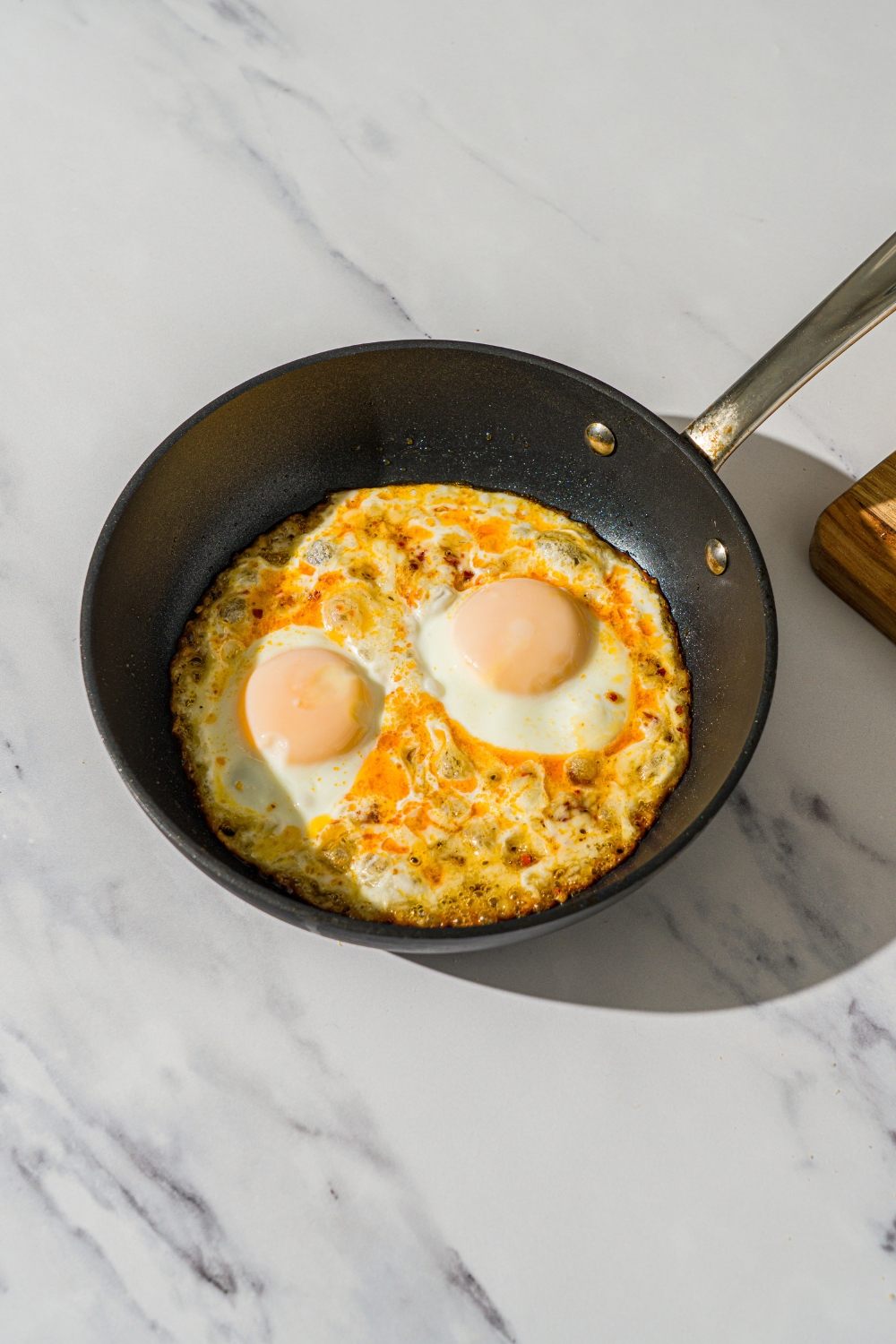 Hot honey eggs cooking in a skillet.