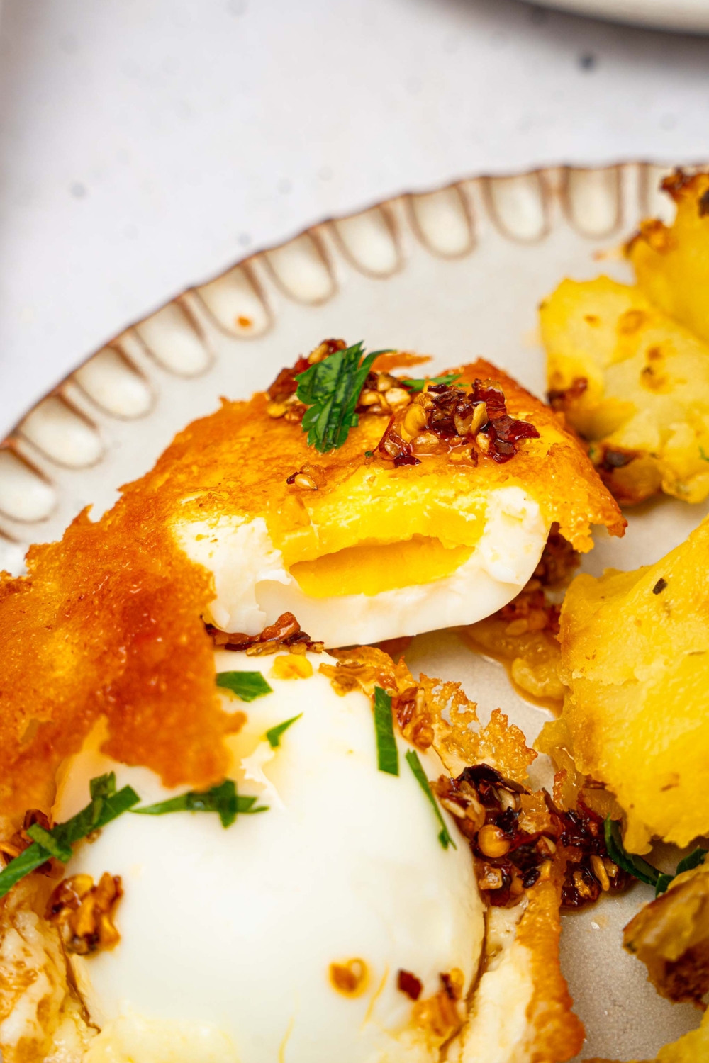 A jammy crispy feta egg on a white plate.