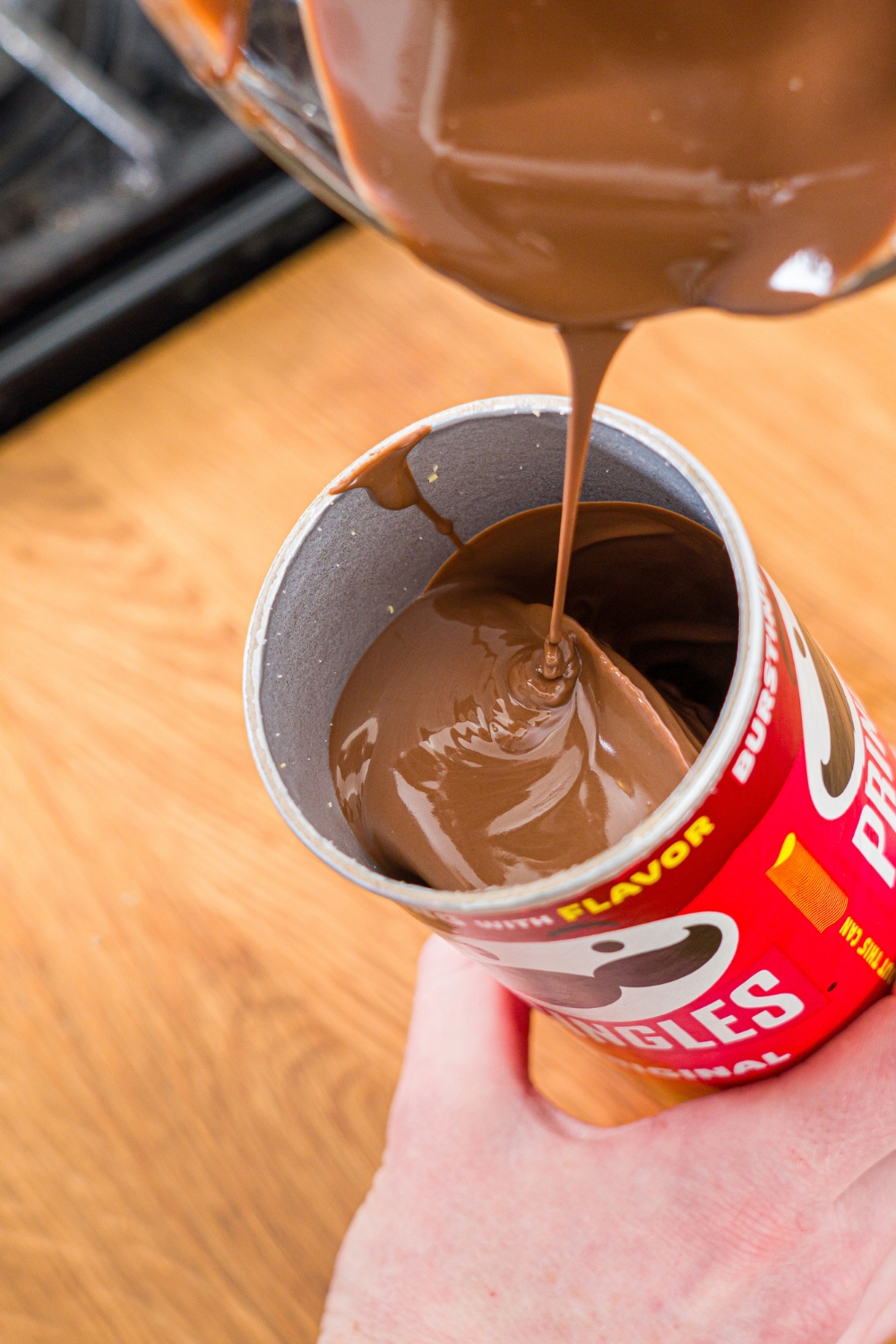 Melted chocolate bean poured into a Pringles can.