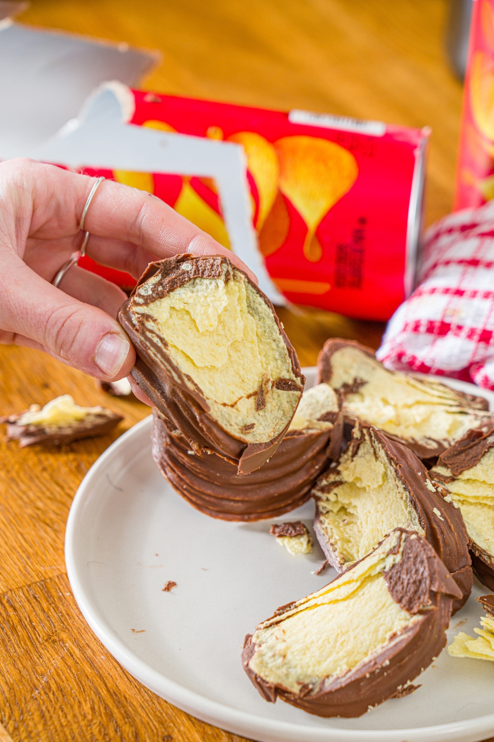 A hand holding a pringles chocolate block.