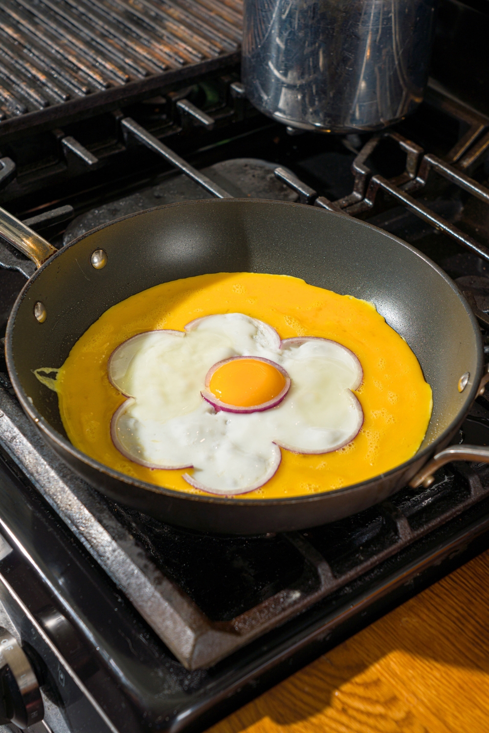 An egg flower omelette cooking in a skillet.