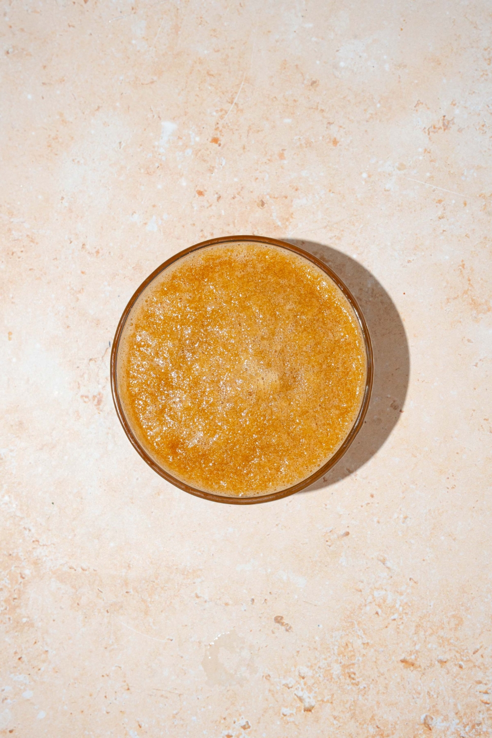 A glass bowl with blended hibachi ginger sauce. The bowl is on a tan counter.