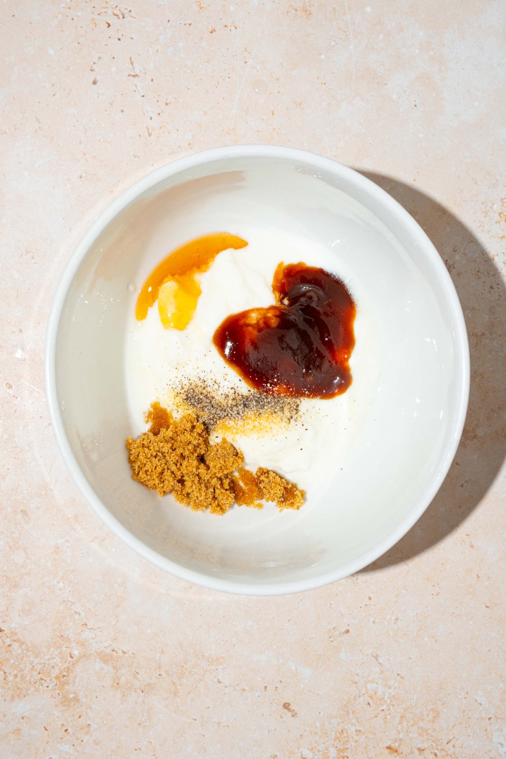 Chipotle sauce, brown sugar, mayo, honey, and mustard and white bowl.