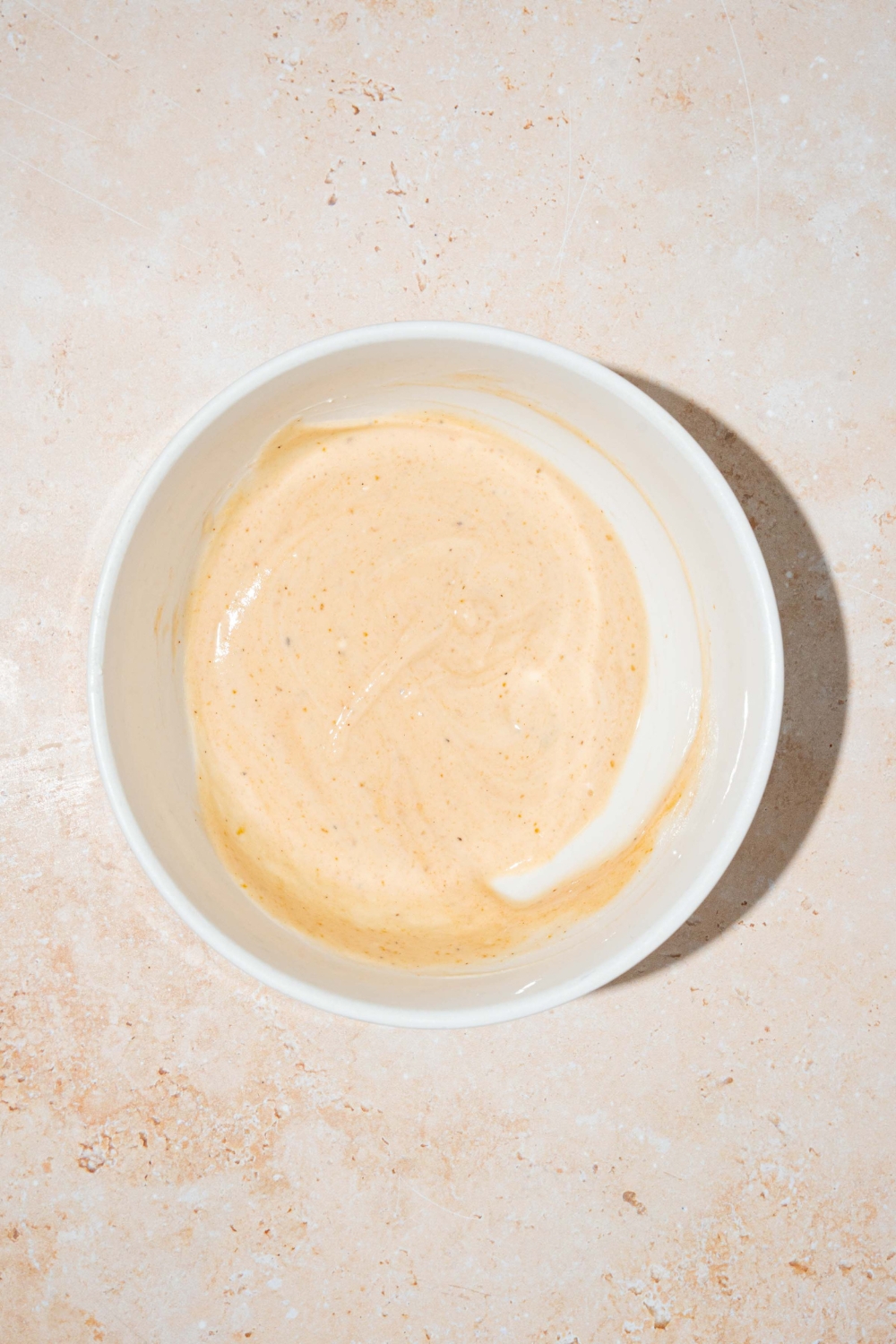 Dave's hot chicken sauce mixed in a white bowl.
