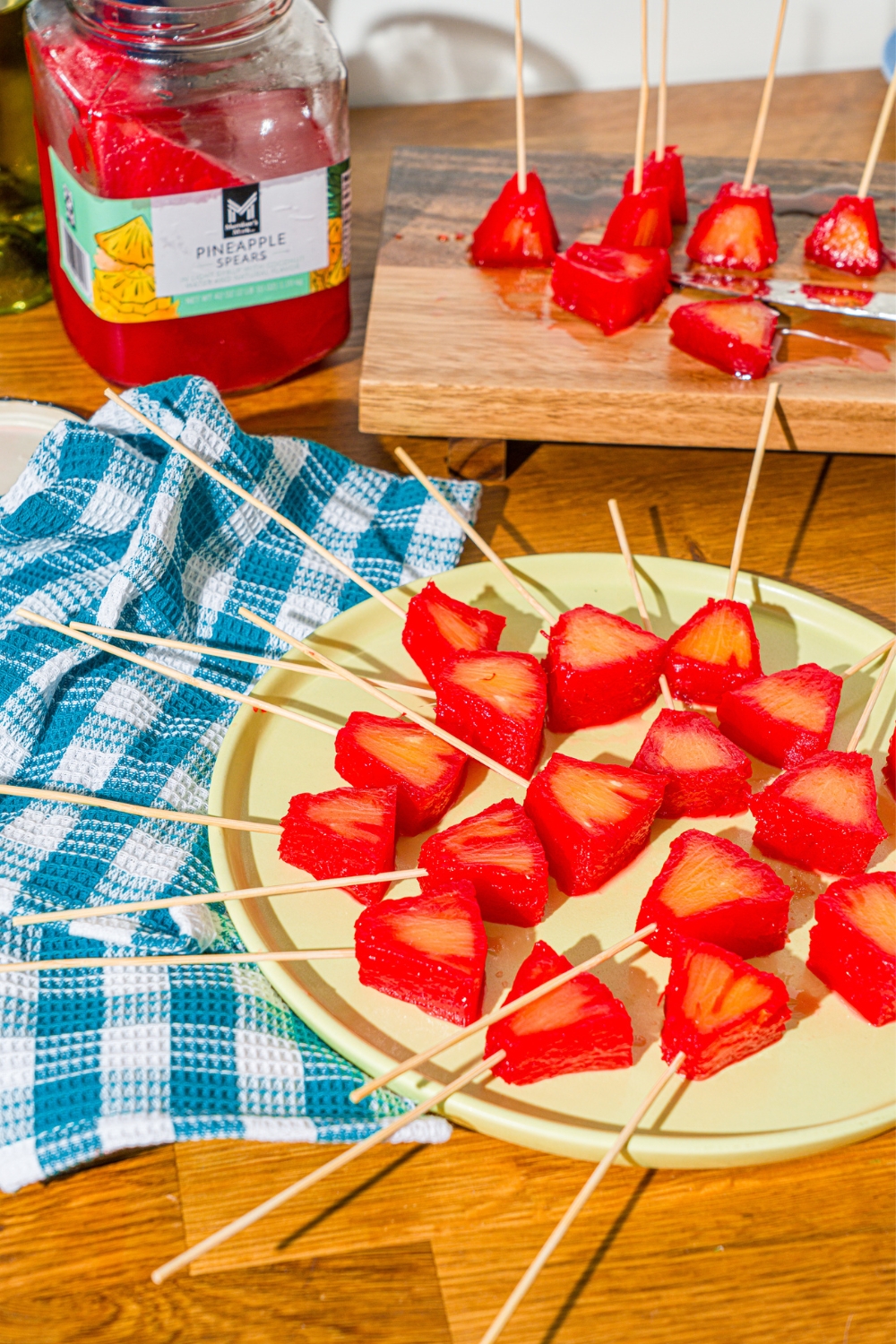 A bunch of Kool-Aid pineapple spears on a green plate.