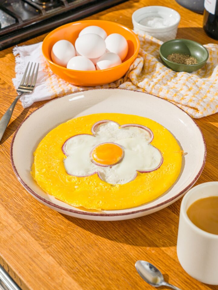 An egg flower omelette on a white plate.