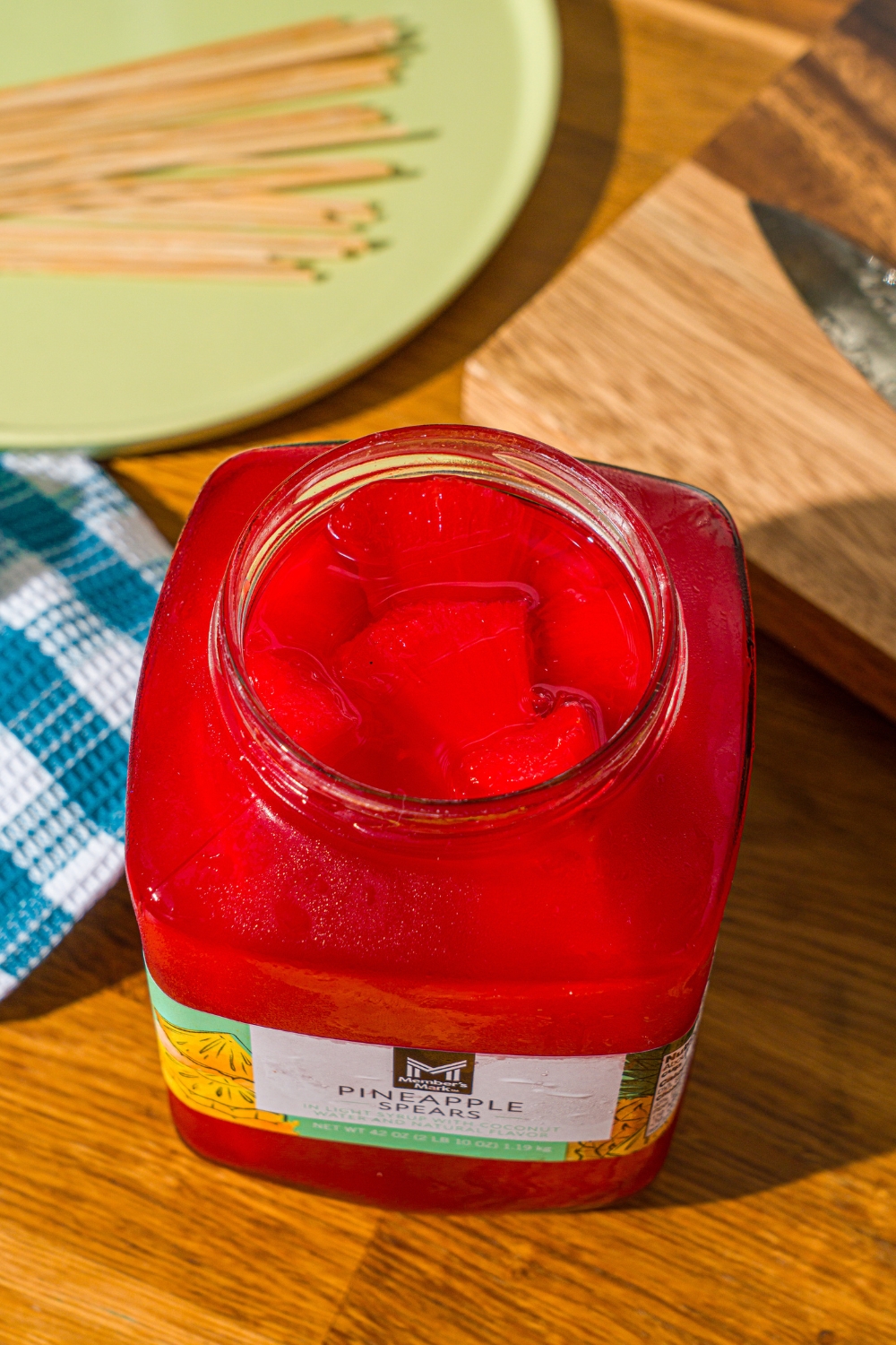 A pineapple jar that is filled with fruit punch, Kool-Aid pineapple spears.