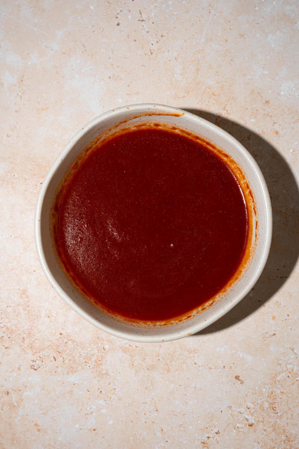 A large white bowl with copycat Bachan Japanese BBQ sauce. The bowl is on a tan counter.
