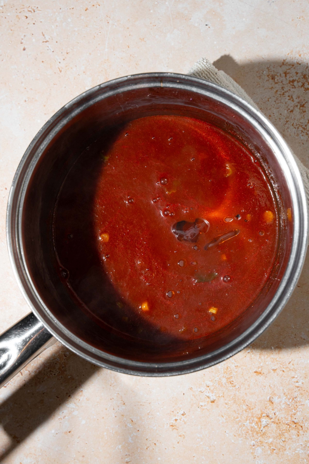 A pot with cooked copycat Bachan Japanese BBQ sauce. The pot is on a tan counter.