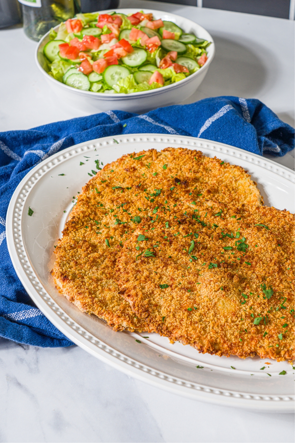 Probably plate that has two ground chicken cutlets on it.