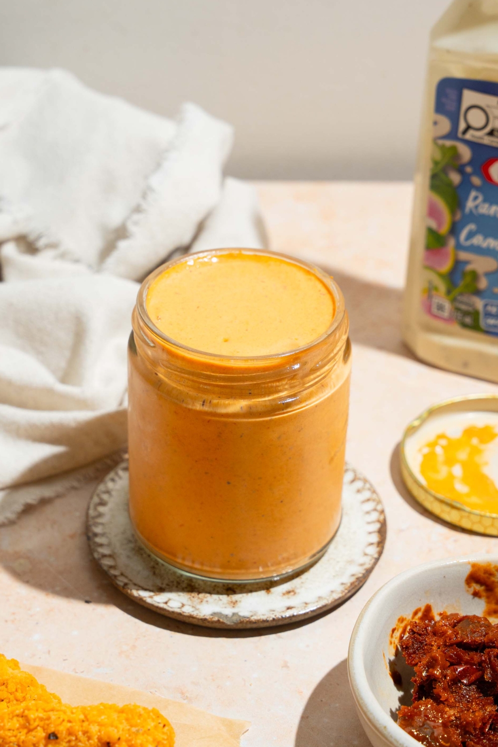 A glass jar is filled with chipotle southwest sauce.