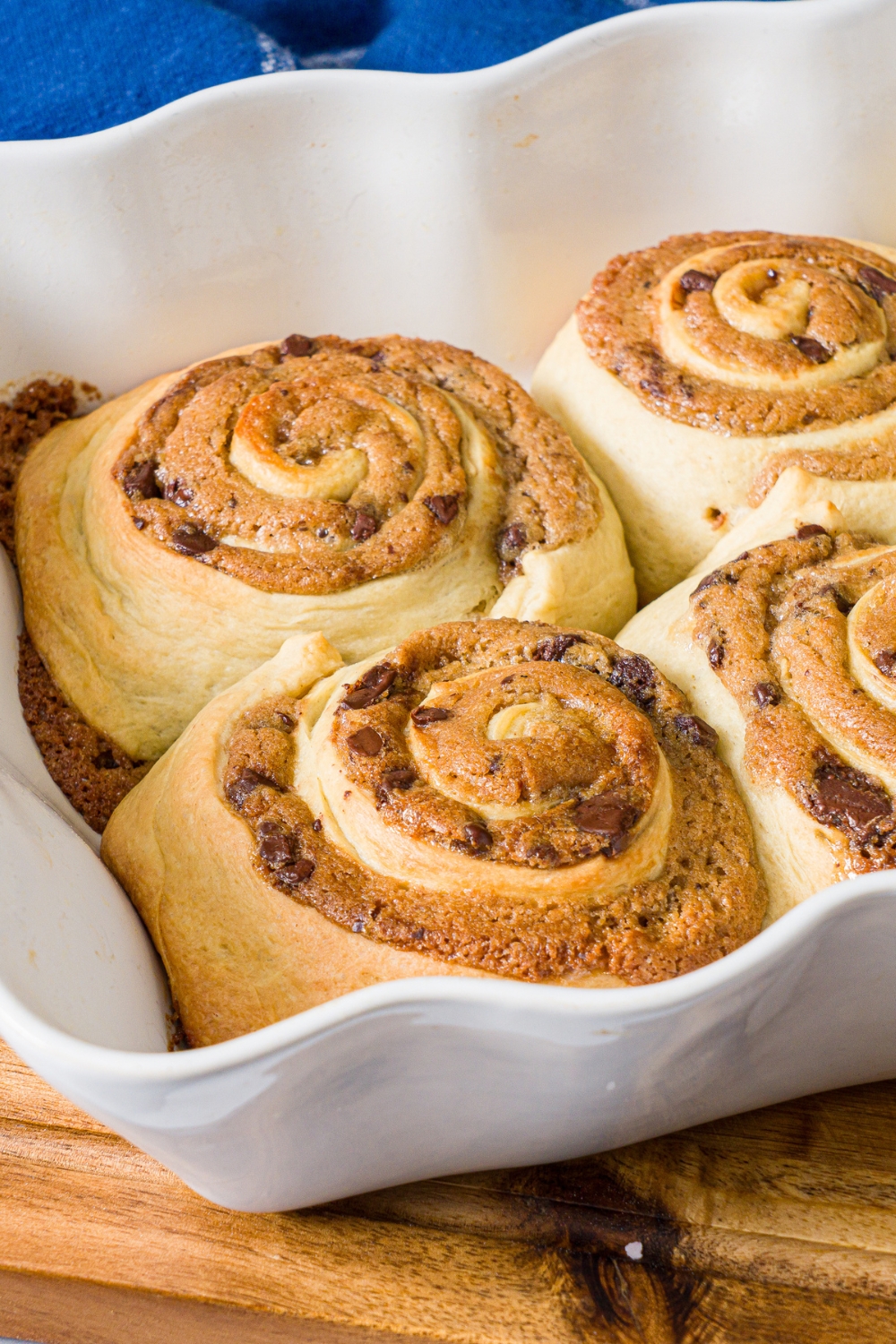 Four cookie dough, cinnamon rolls, and a white tray.