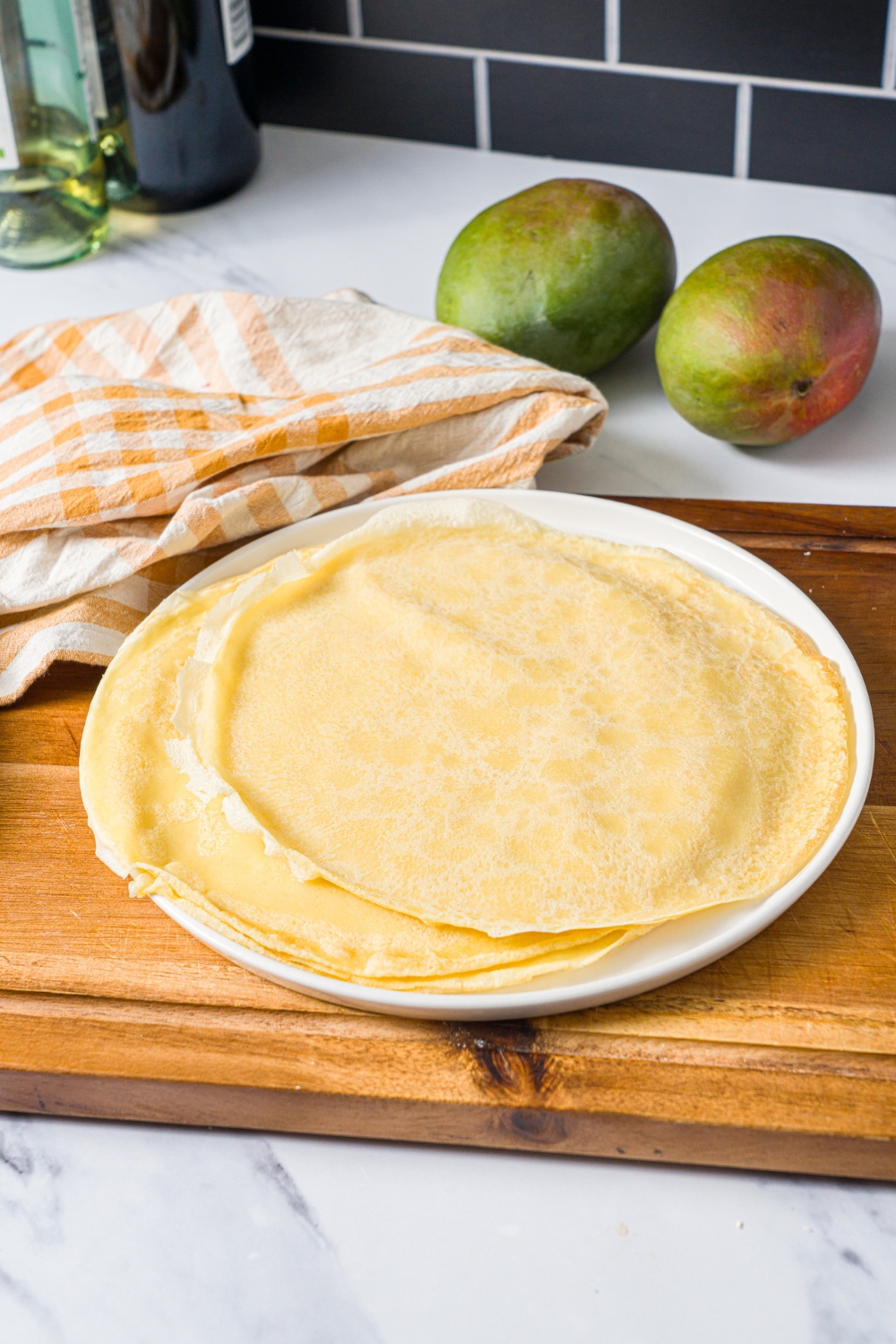 A bunch of crêpes on top of one another for mango pancakes.