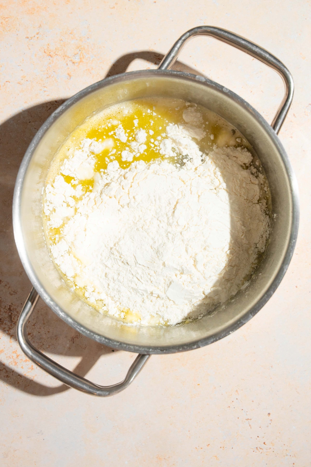 Melted butter and flour in a stainless steel pot.