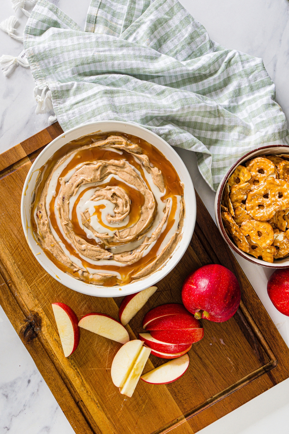 Cinnamon bun dip with caramel sauce and icing drizzled on top.