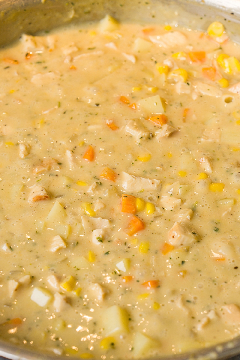 A skillet with chicken pot pie filling.