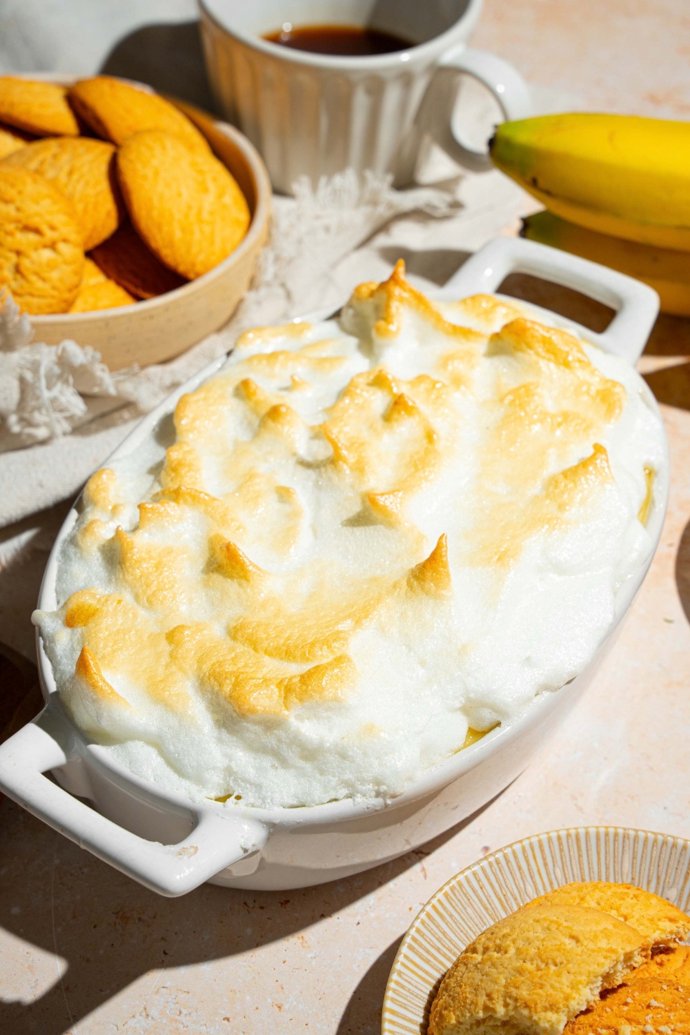 A baked southern style banana pudding in a white casserole dish.