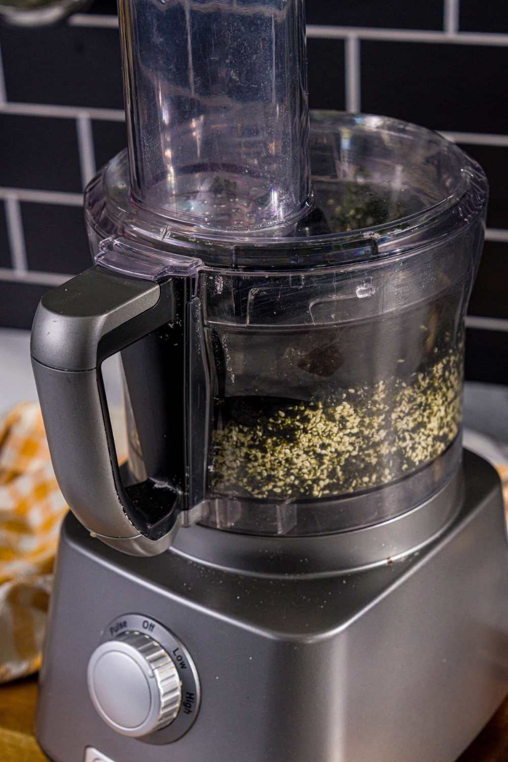 A food processor with finely chopped nori seaweed.