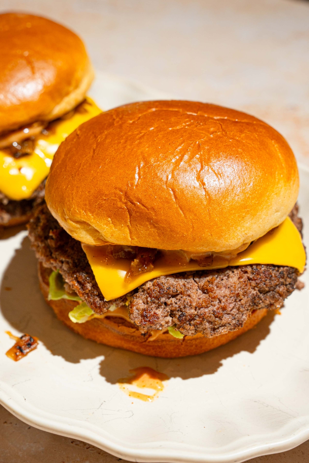 An assembled double Smashburger with American cheese and lettuce on a bun.
