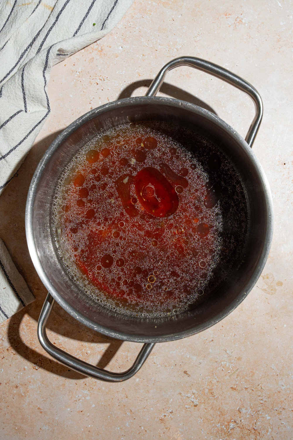 Garlic ginger broth cooking in a large pot.
